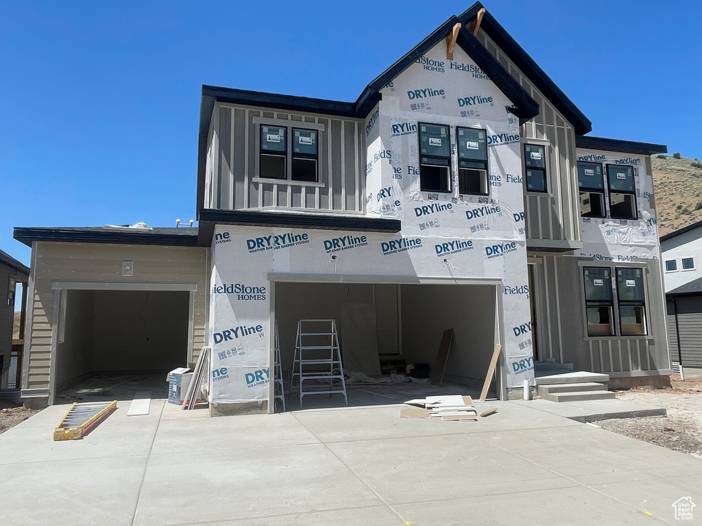 View of building exterior featuring driveway and an attached garage