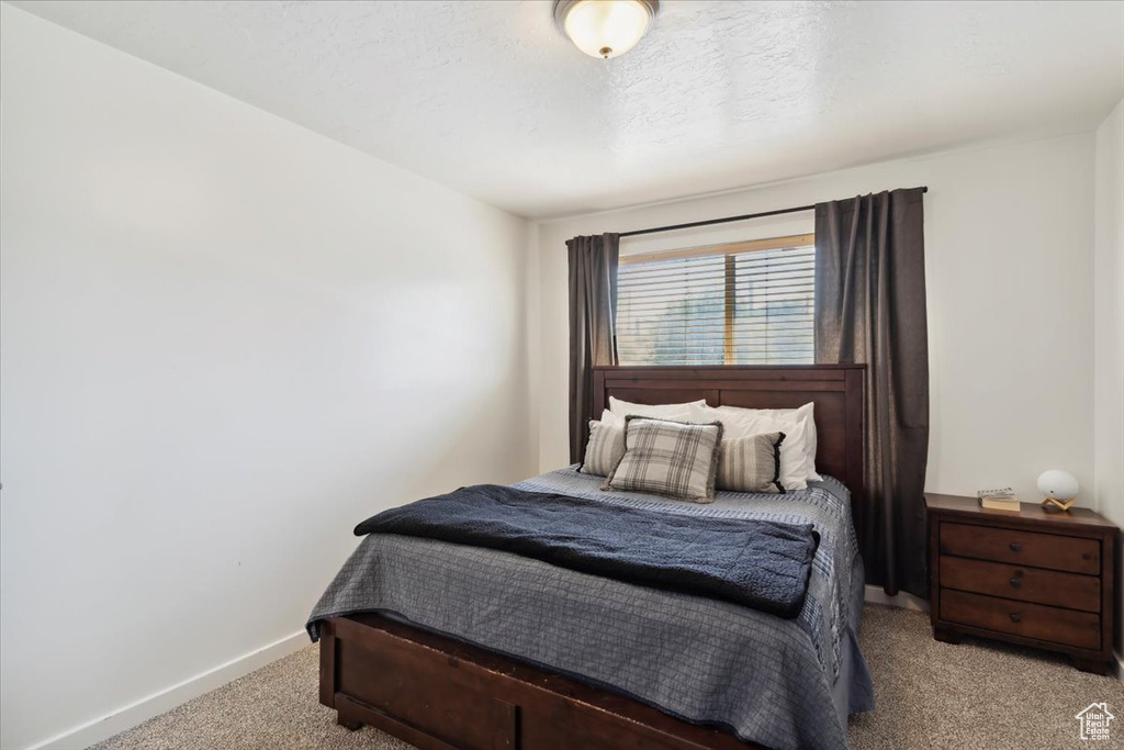 Bedroom with carpet and baseboards