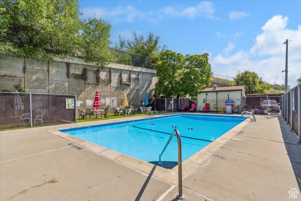 Community pool with a patio
