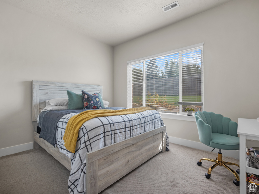 Carpeted bedroom with baseboards