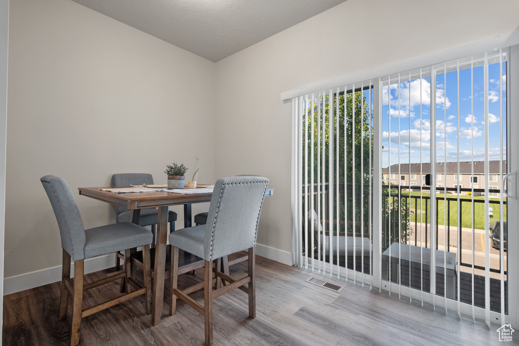 Dining area with baseboards and wood finished floors