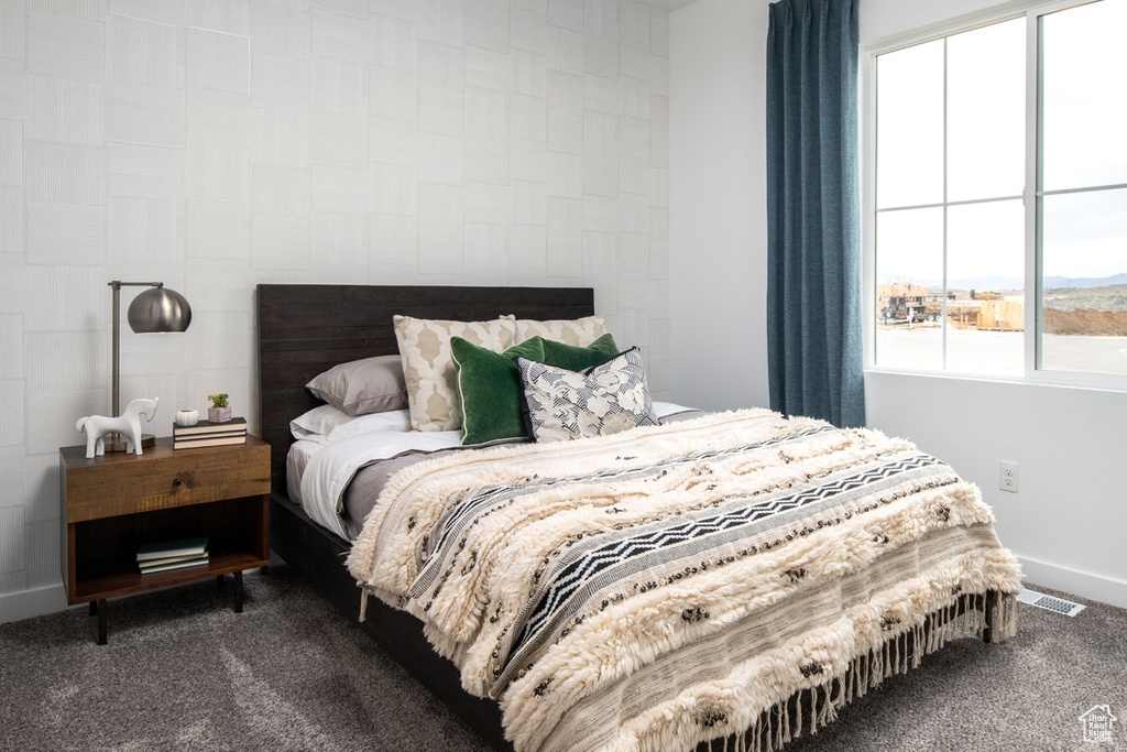 Carpeted bedroom featuring baseboards