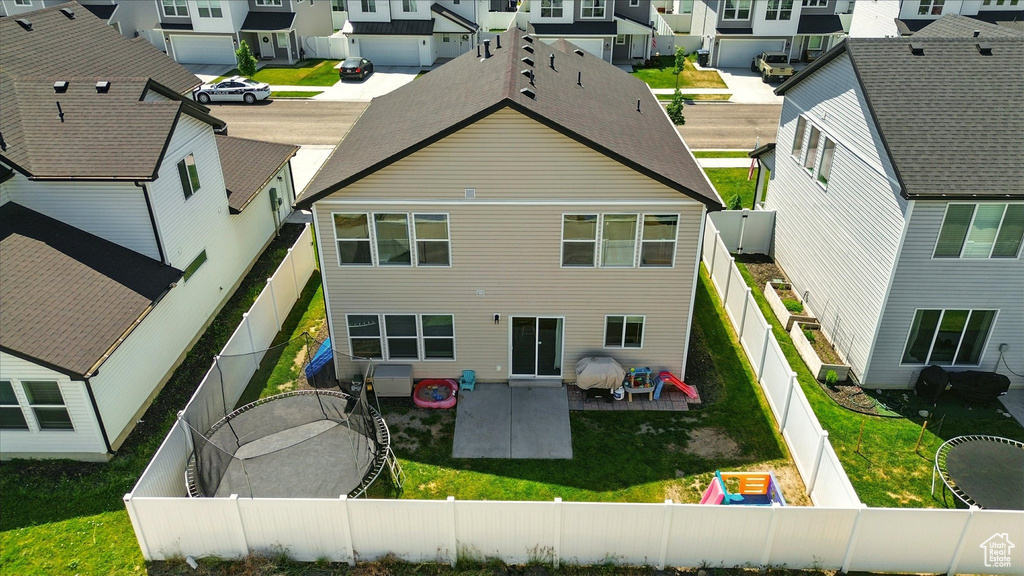 Rear view of property featuring a residential view, a patio, and a fenced backyard