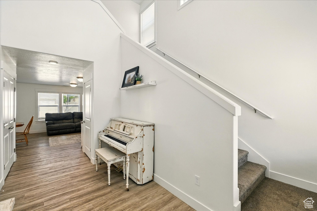 Stairs with baseboards and wood finished floors
