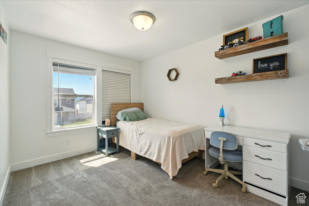 Carpeted bedroom featuring baseboards