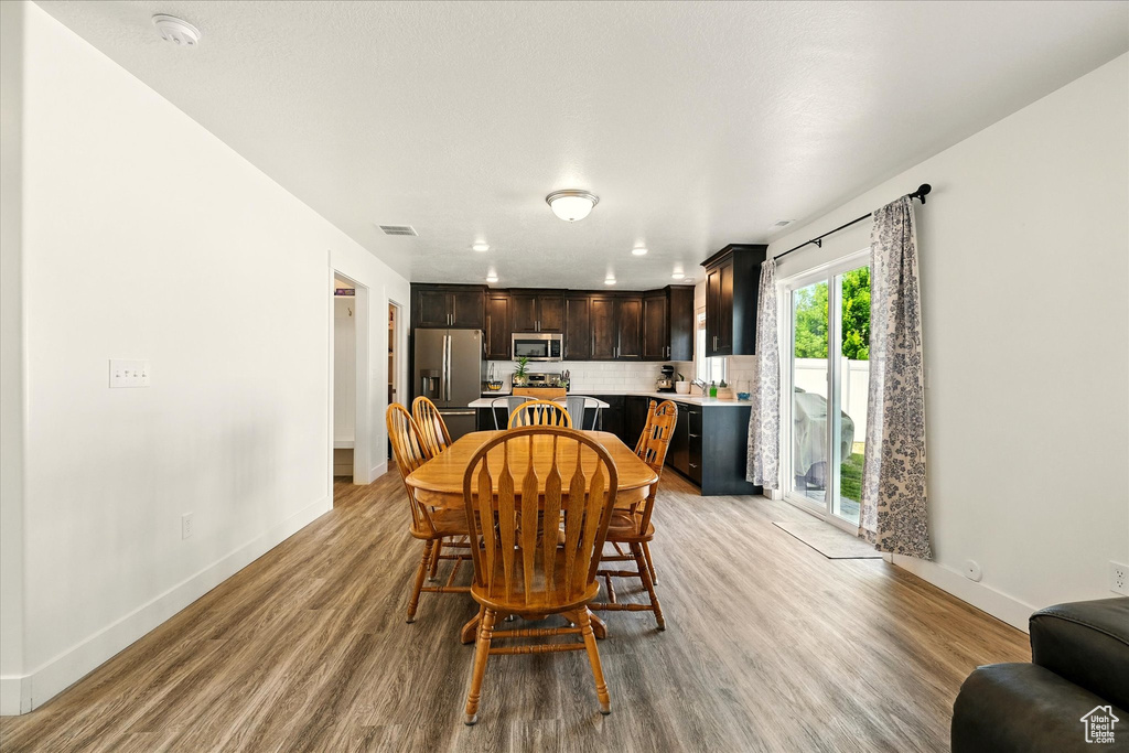 Dining space with light wood-style floors and baseboards