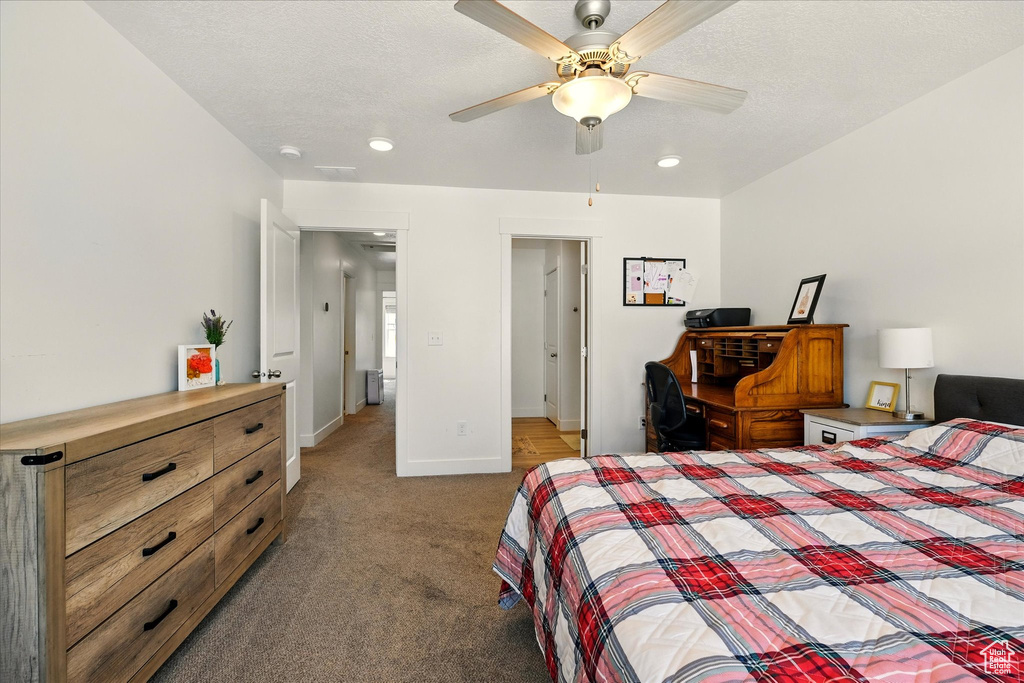 Carpeted bedroom with baseboards, recessed lighting, and a ceiling fan