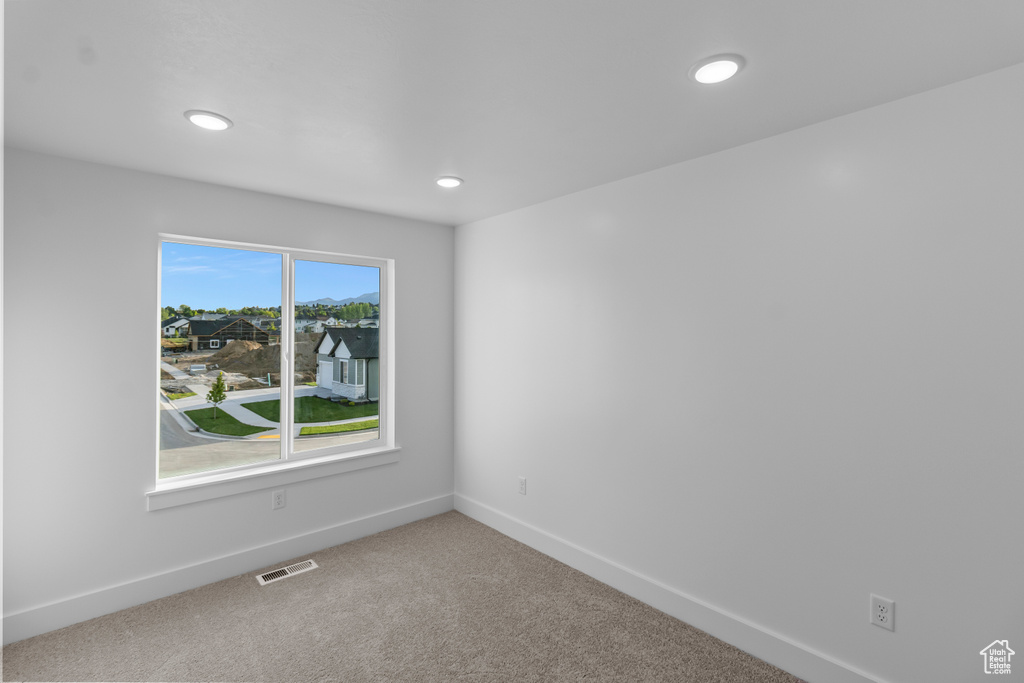 Empty room with recessed lighting, baseboards, and carpet floors