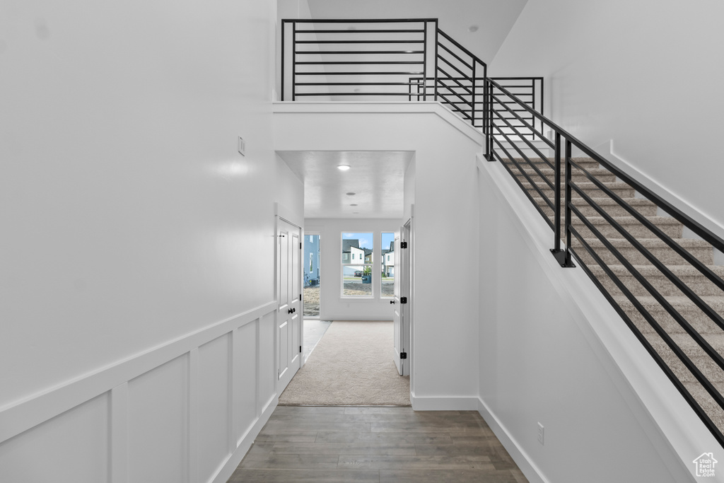 Stairway with wood finished floors and baseboards