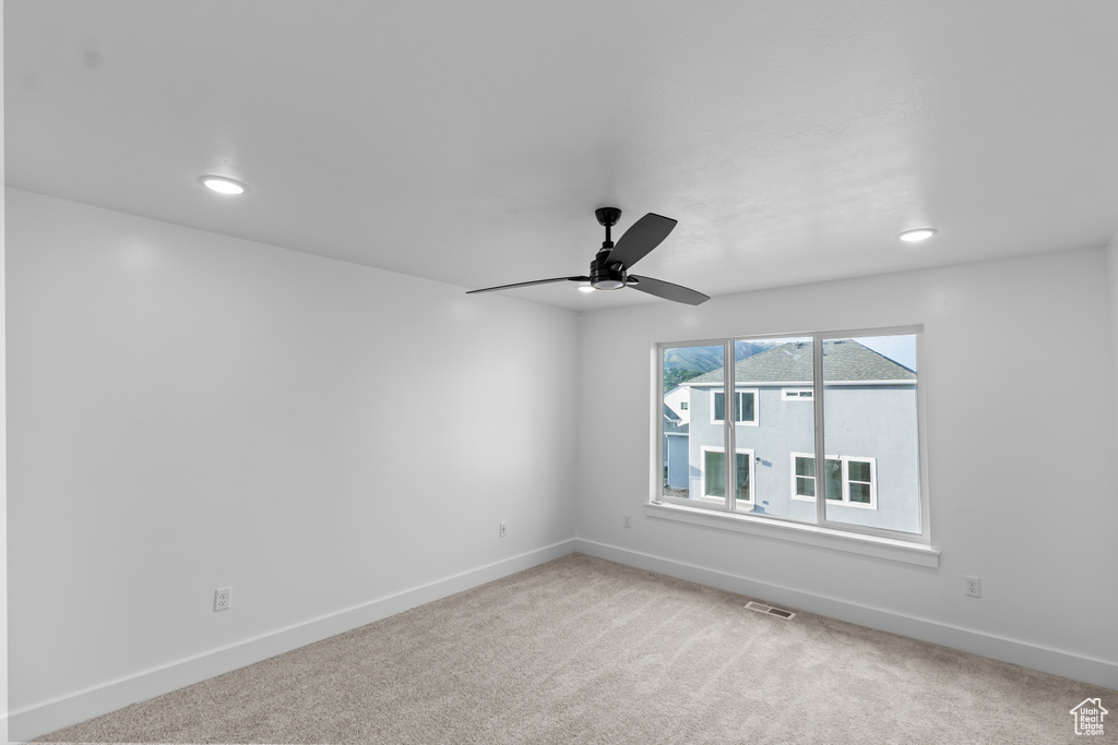 Spare room with baseboards, light carpet, a ceiling fan, and recessed lighting