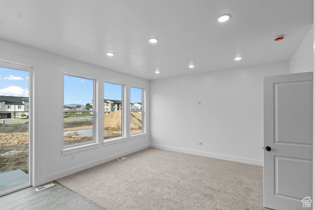 Unfurnished room featuring baseboards and recessed lighting
