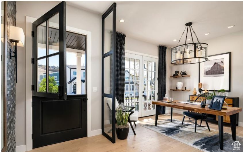 Foyer featuring plenty of natural light, wood finished floors, baseboards, recessed lighting, and a chandelier