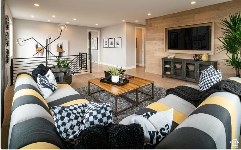 Living area featuring recessed lighting, wood finished floors, and baseboards