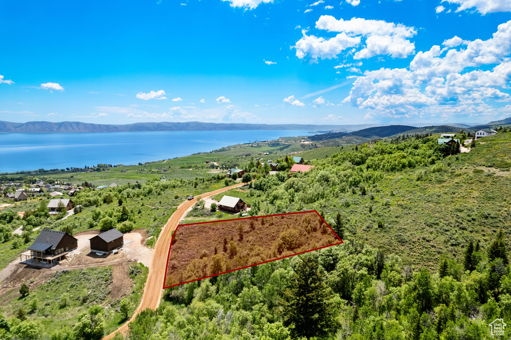 View of property location featuring a water and mountain view and property parcel outlined