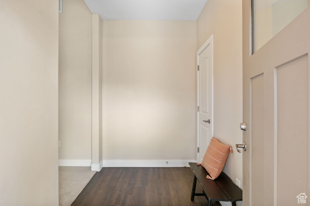 Hall featuring dark wood finished floors and baseboards