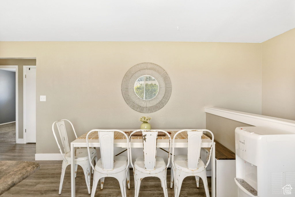 Dining space featuring wood finished floors and baseboards