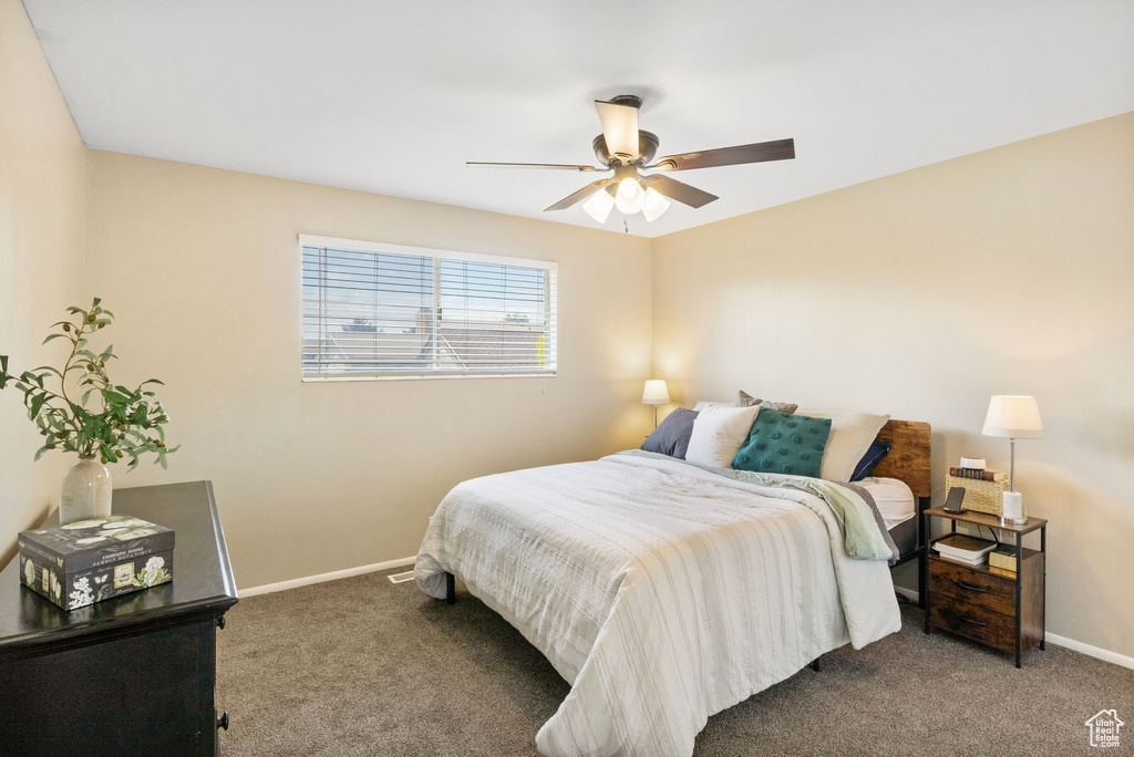 Bedroom featuring carpet, baseboards, and ceiling fan