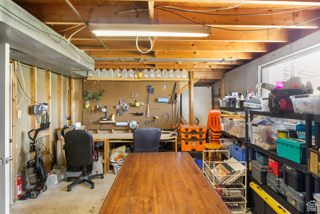 Unfinished basement featuring a workshop area