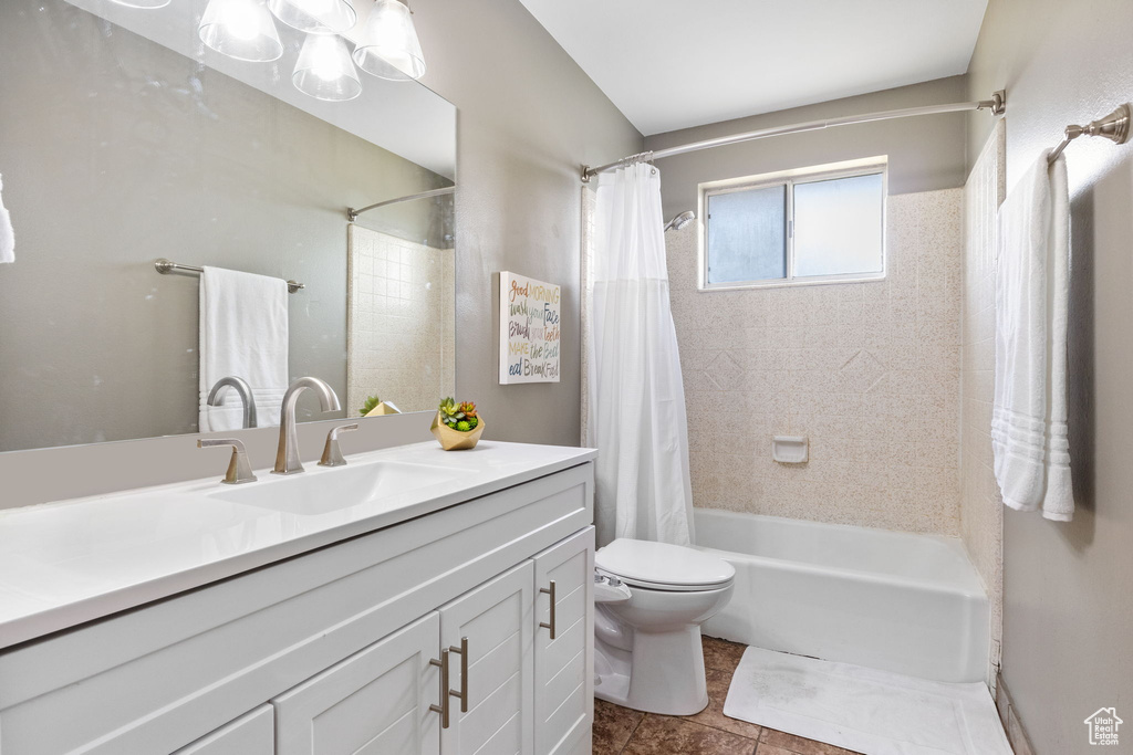 Bathroom with vanity, shower / bath combo with shower curtain, toilet, and tile patterned flooring