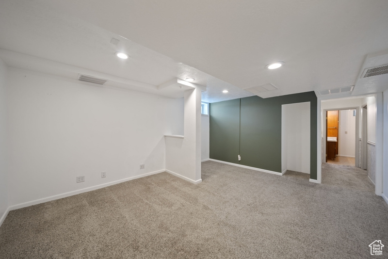 Finished basement featuring carpet, recessed lighting, and baseboards