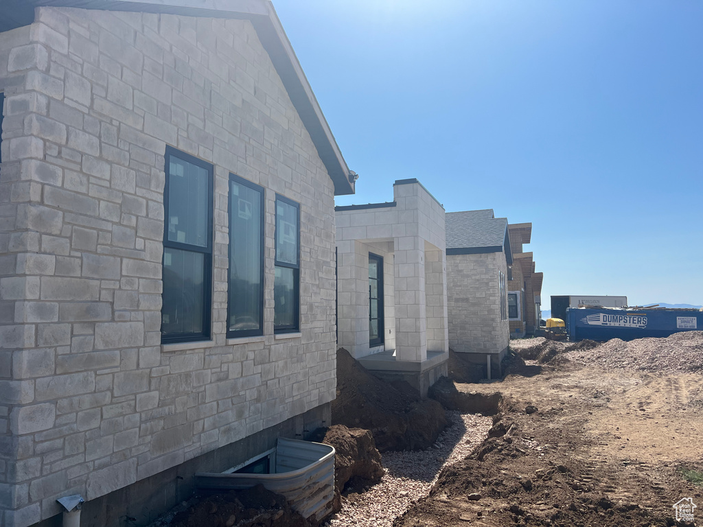 View of side of home with stone siding