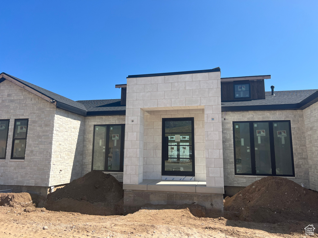 Back of property with stone siding