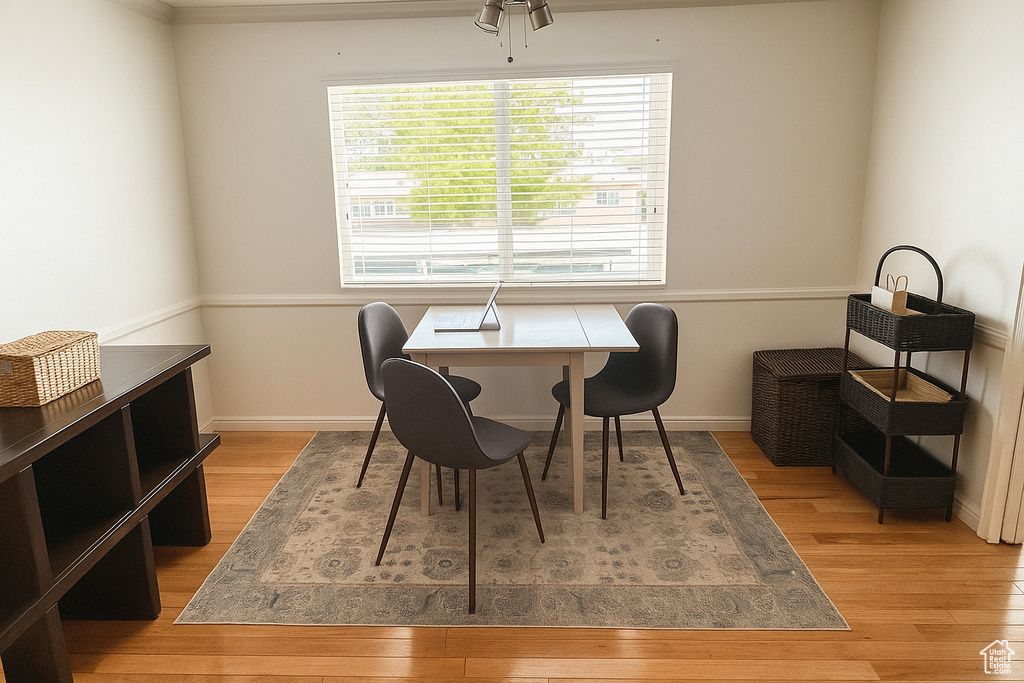 Dining area with light wood finished floors and baseboards