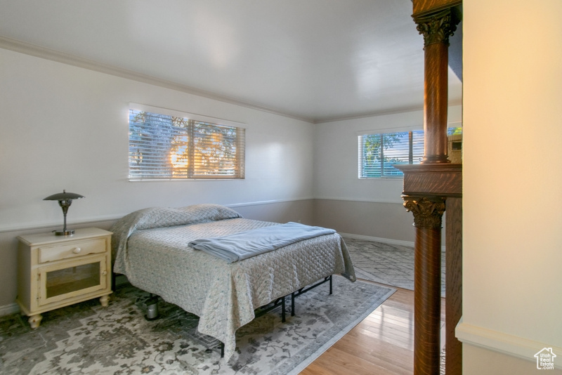 Bedroom featuring light wood-style flooring and ornamental molding