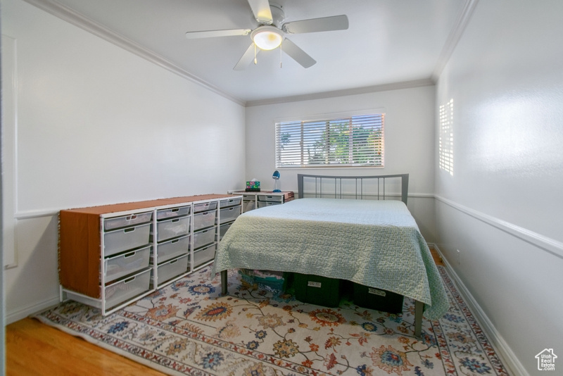 Bedroom featuring ornamental molding and ceiling fan