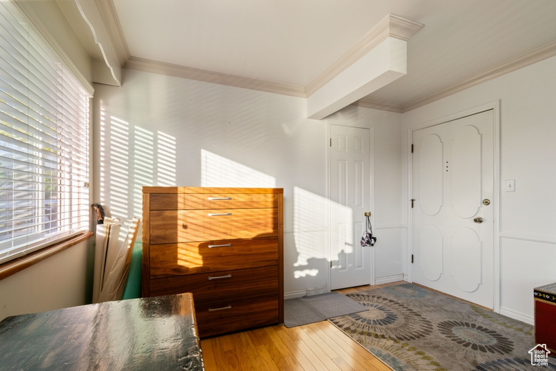 Foyer featuring crown molding and hardwood / wood-style floors