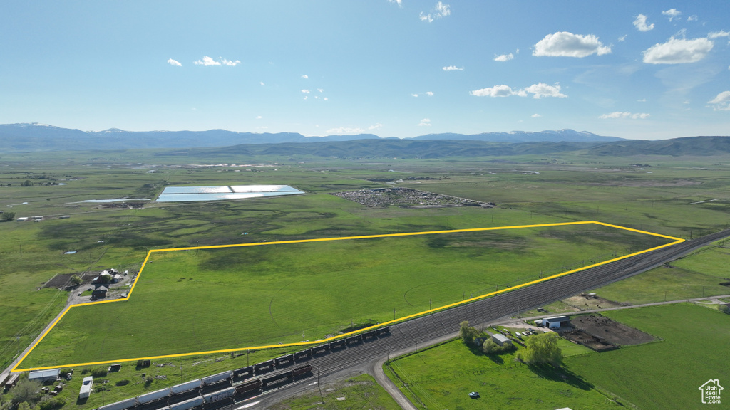 Overview of rural landscape featuring property boundaries highlighted and a mountainous background