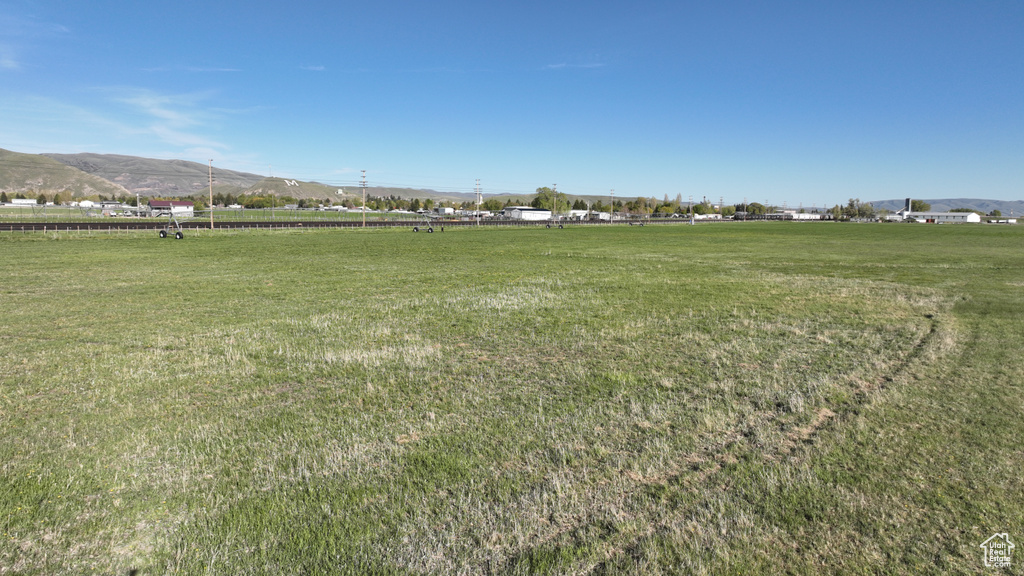 View of green lawn featuring a view of countryside and a mountain view
