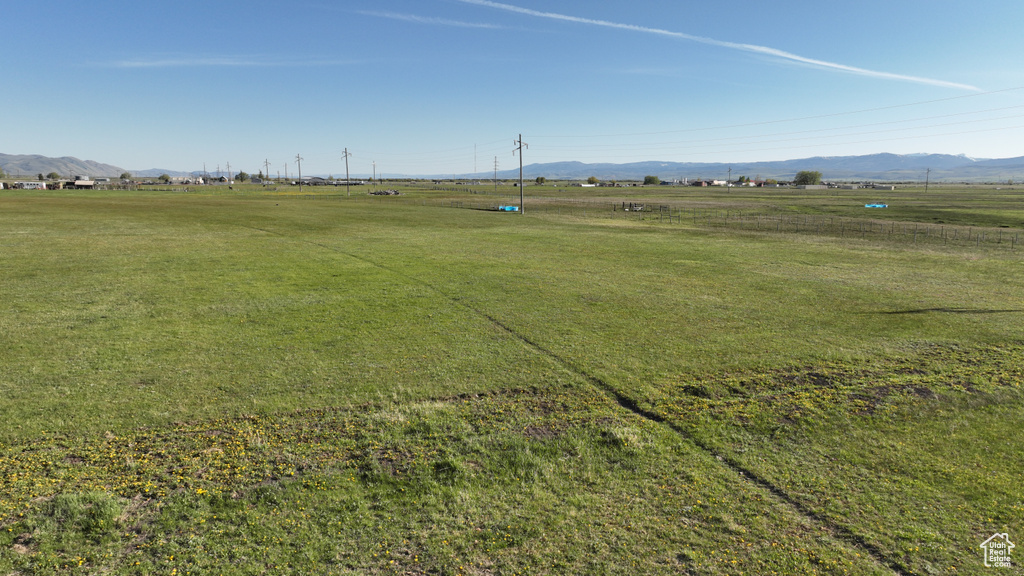 View of home's community with a view of rural / pastoral area, a mountain view, and a lawn