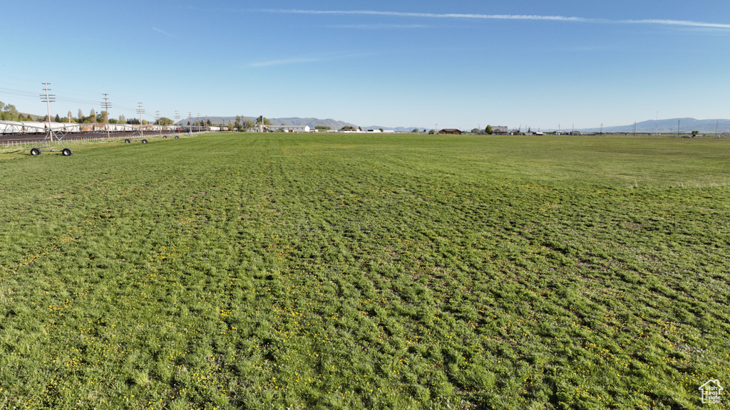 View of grassy yard featuring a mountain view and a view of rural / pastoral area