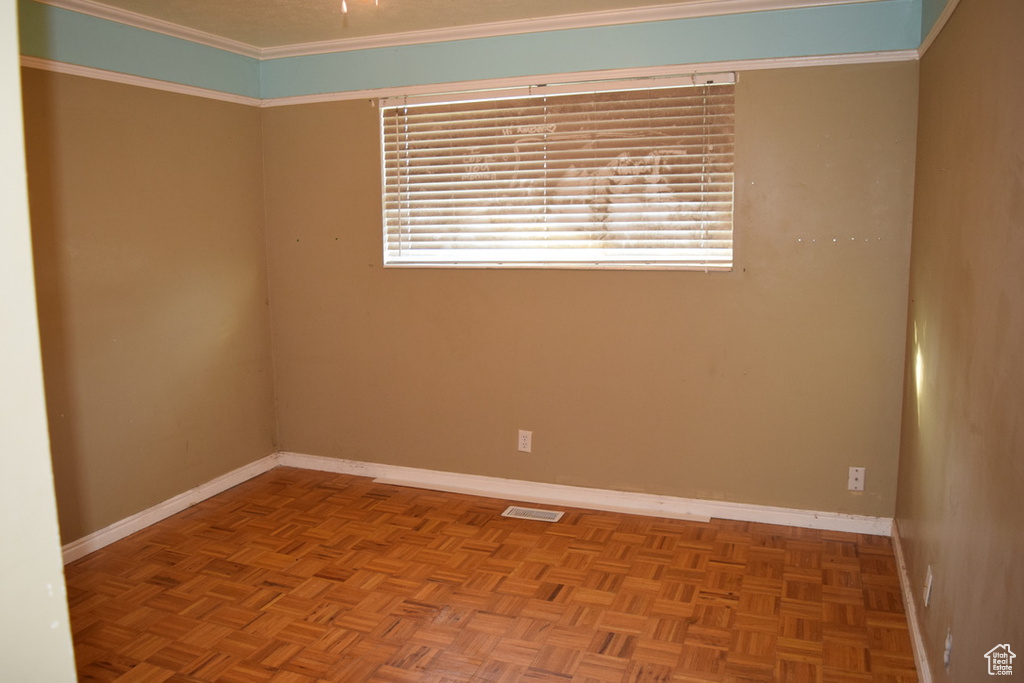 Empty room with baseboards and ornamental molding
