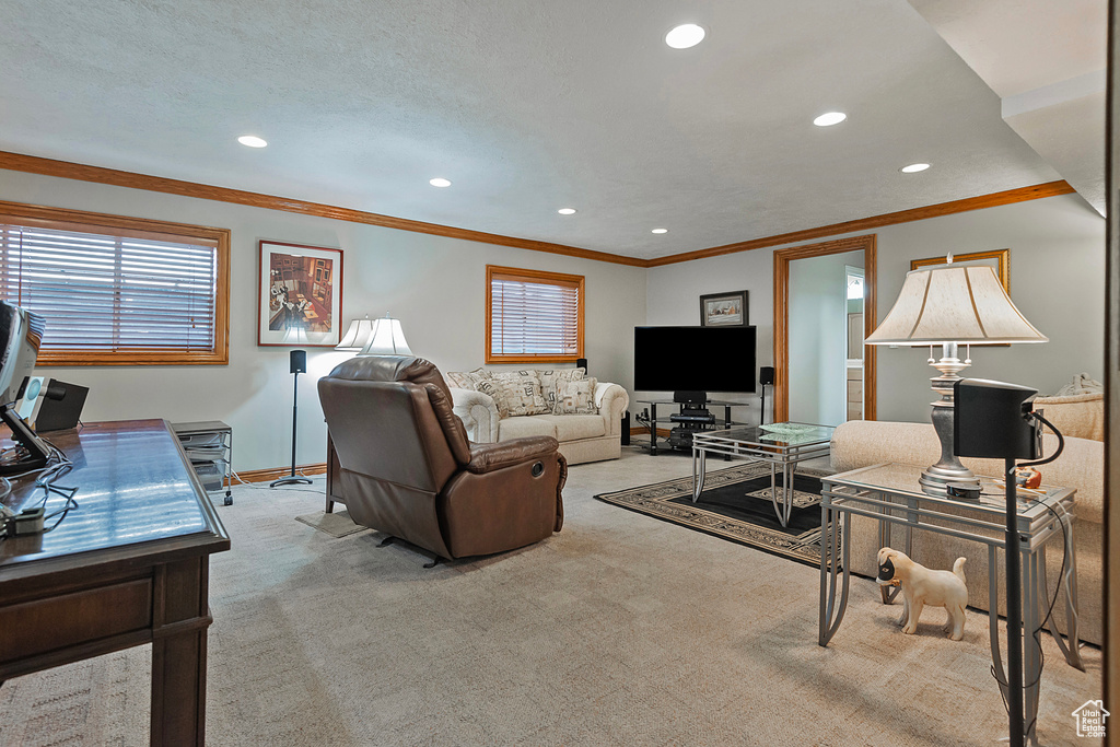 Living area featuring recessed lighting, baseboards, crown molding, and light carpet
