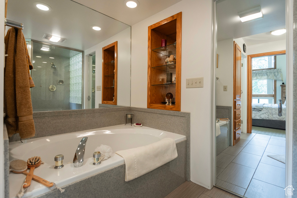 Full bath with ensuite bath, a garden tub, a stall shower, tile patterned floors, and recessed lighting
