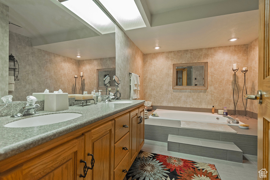 Full bathroom with a bath, double vanity, and tile patterned floors