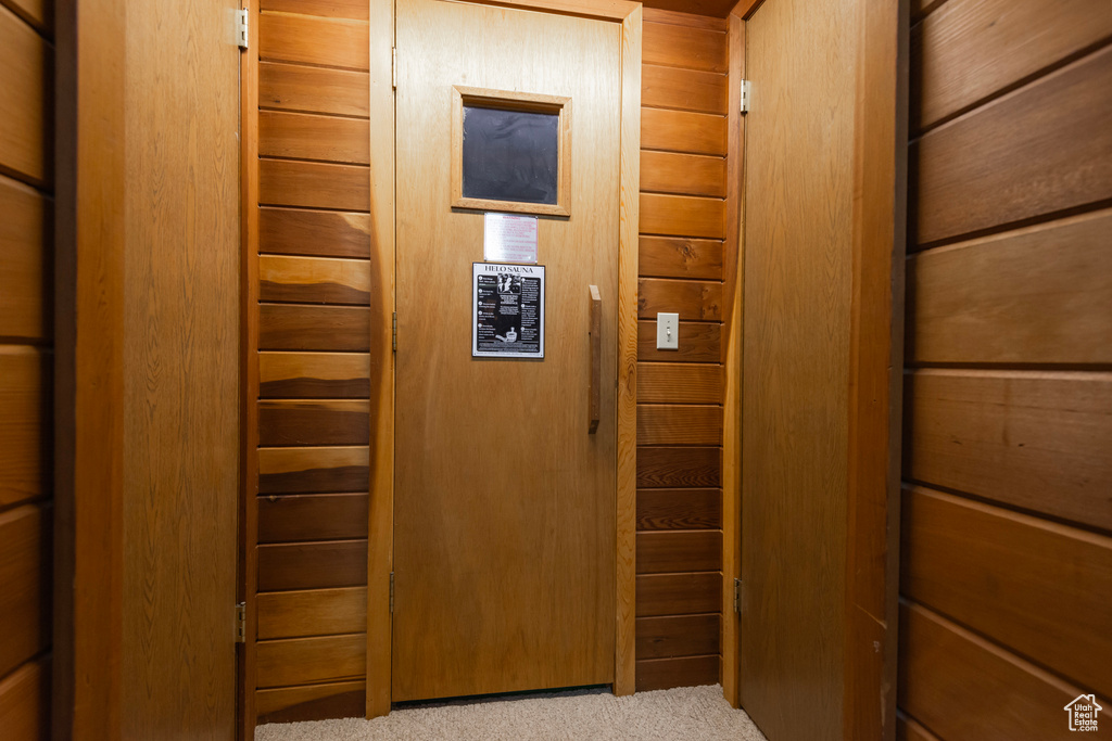 Hallway featuring light carpet
