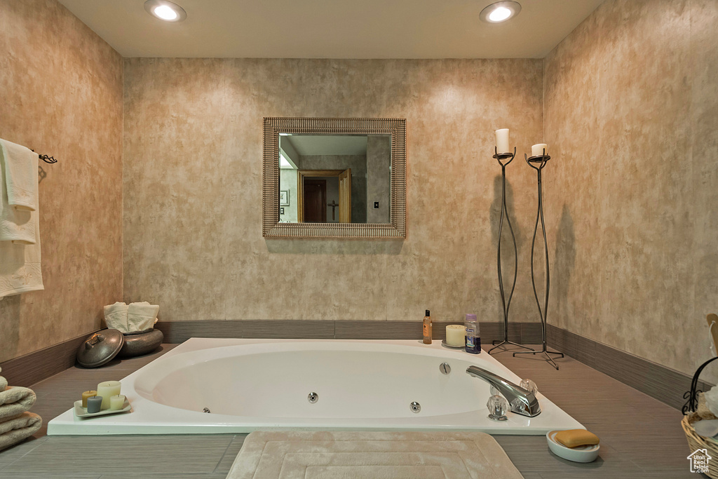 Bathroom featuring a tub with jets and recessed lighting