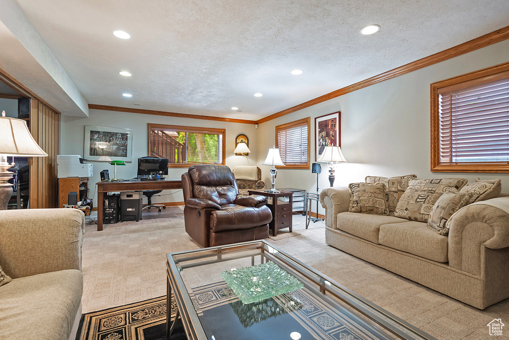 Living room featuring an office area, recessed lighting, ornamental molding, carpet, and a textured ceiling