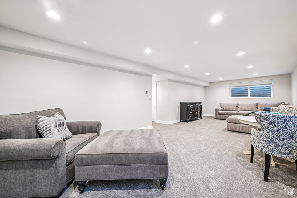Carpeted living area featuring recessed lighting and baseboards