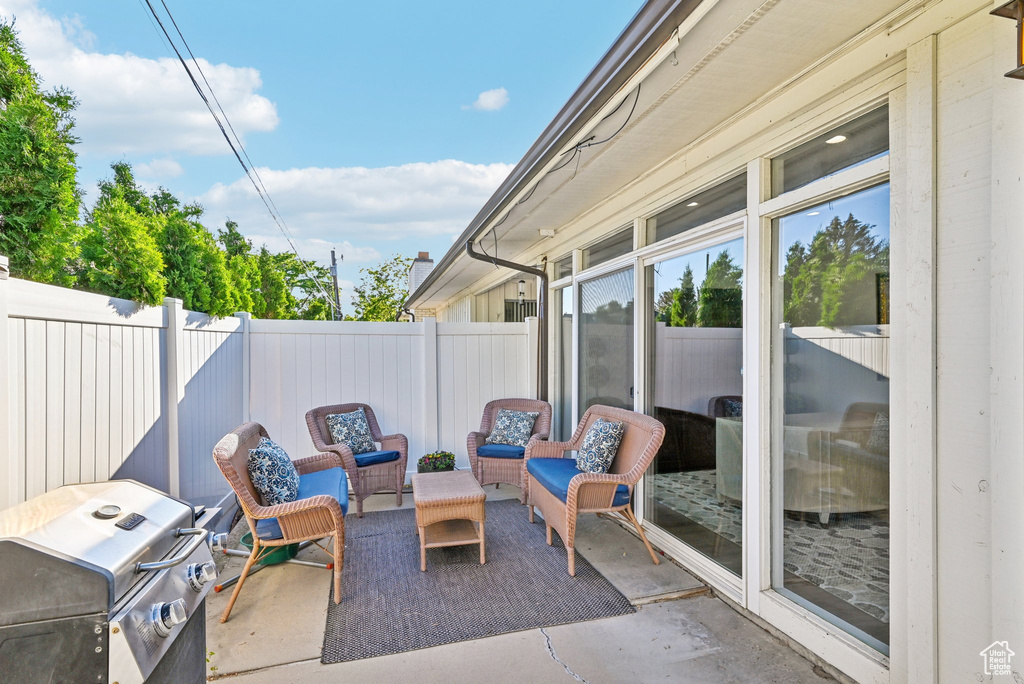 Fenced backyard featuring a patio area, area for grilling, and an outdoor living space