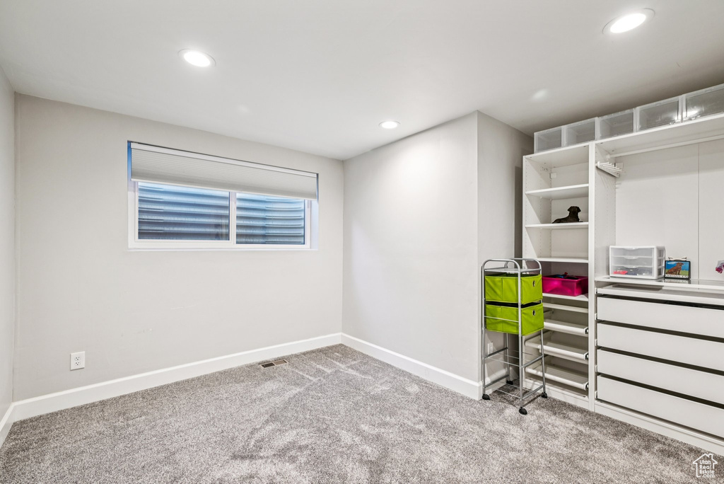 Carpeted bedroom with recessed lighting and baseboards