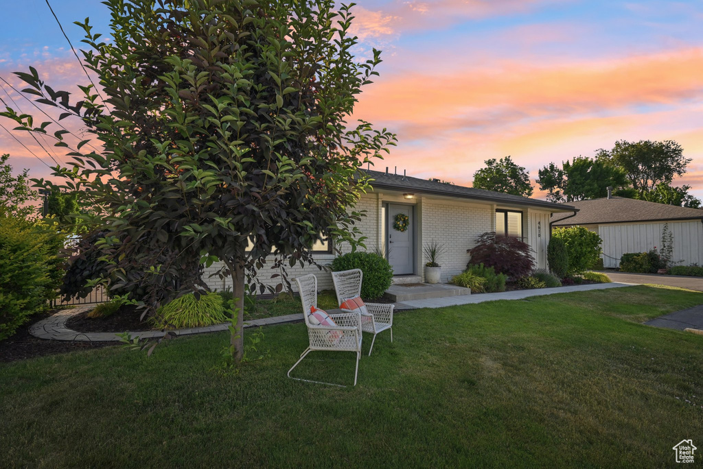 View of front of home with a front lawn and brick siding