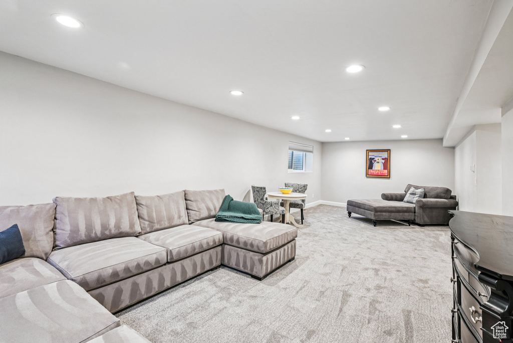 Carpeted living area featuring recessed lighting and baseboards