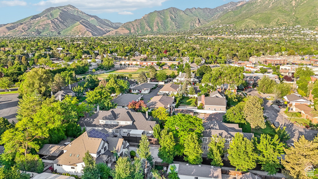 Aerial view of property's location with a mountain backdrop and nearby suburban area