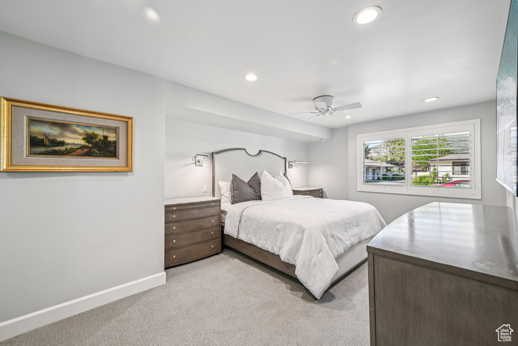 Bedroom with light colored carpet, recessed lighting, baseboards, and a ceiling fan