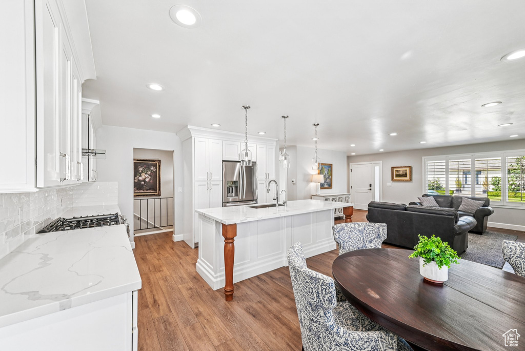 Dining room featuring recessed lighting, baseboards, and light wood-type flooring