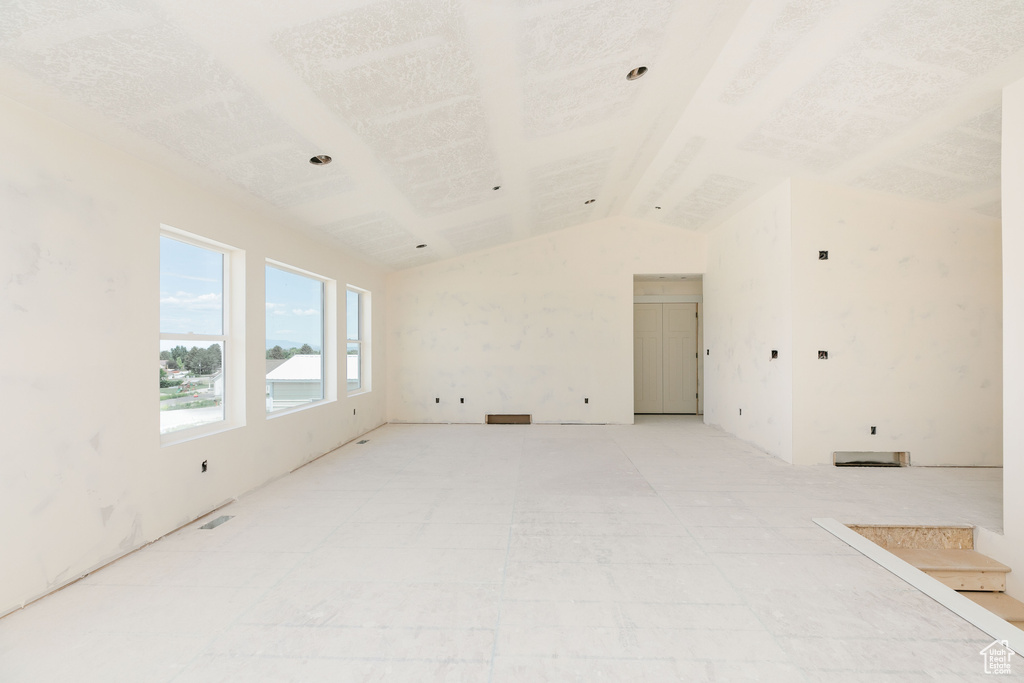 Spare room featuring lofted ceiling